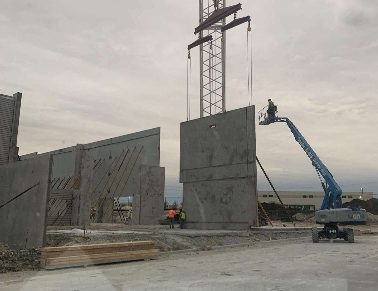 Crane setting panel on tilt-up construction site